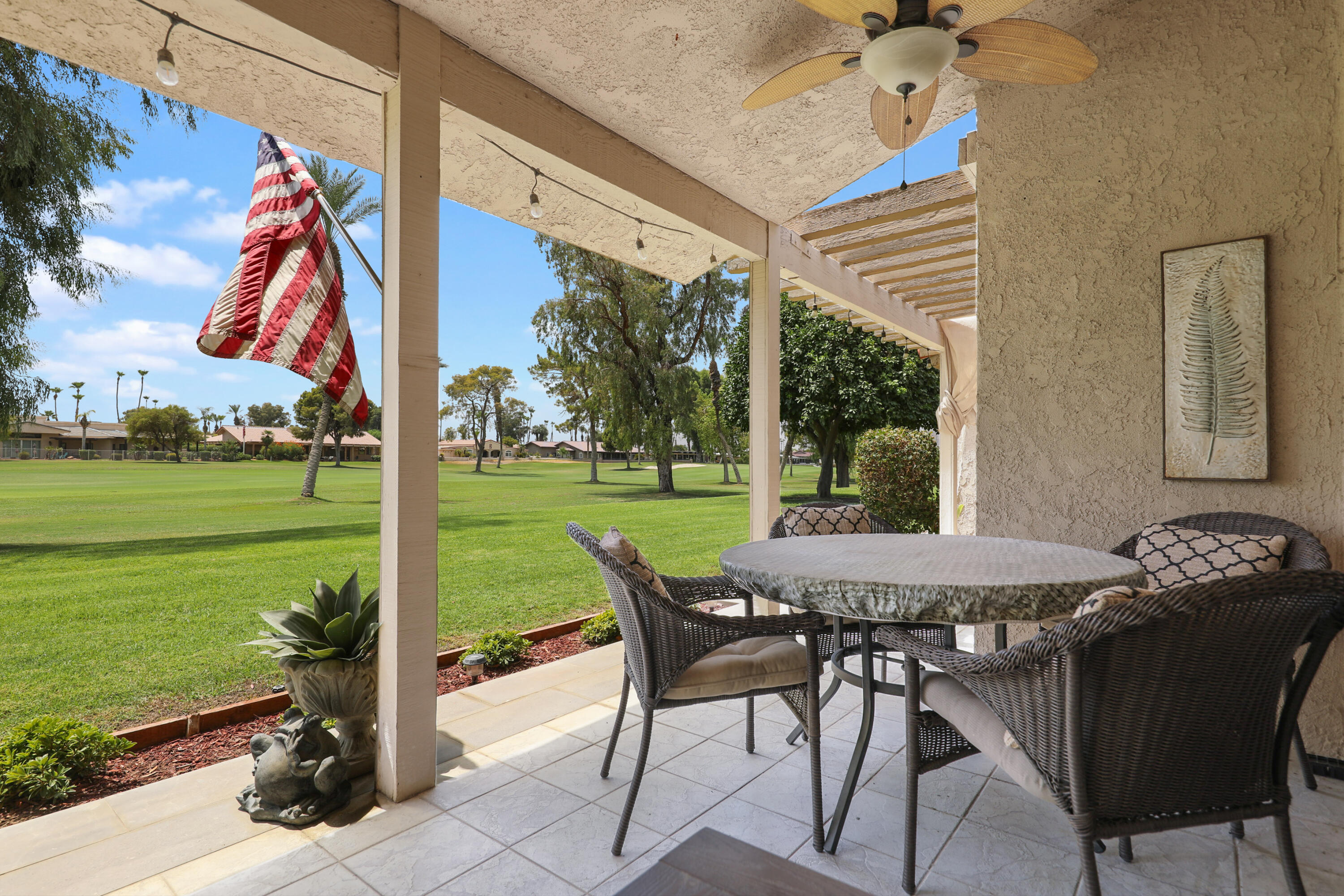 a view of a patio with a table chairs and a backyard