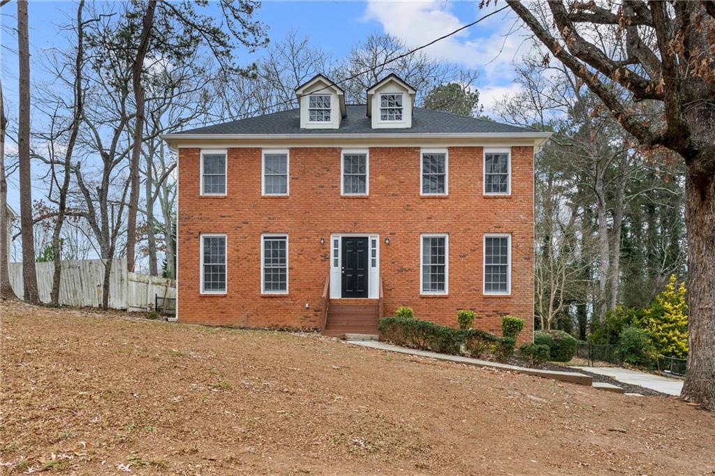 front view of brick house with a yard