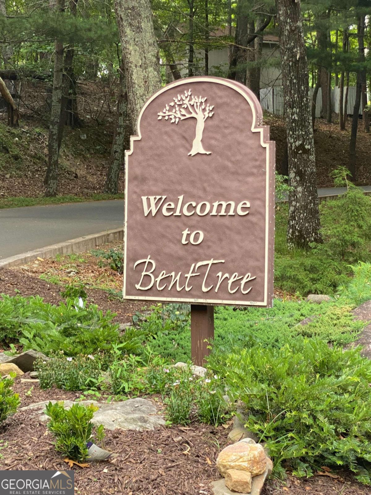 a view of sign board with a lake