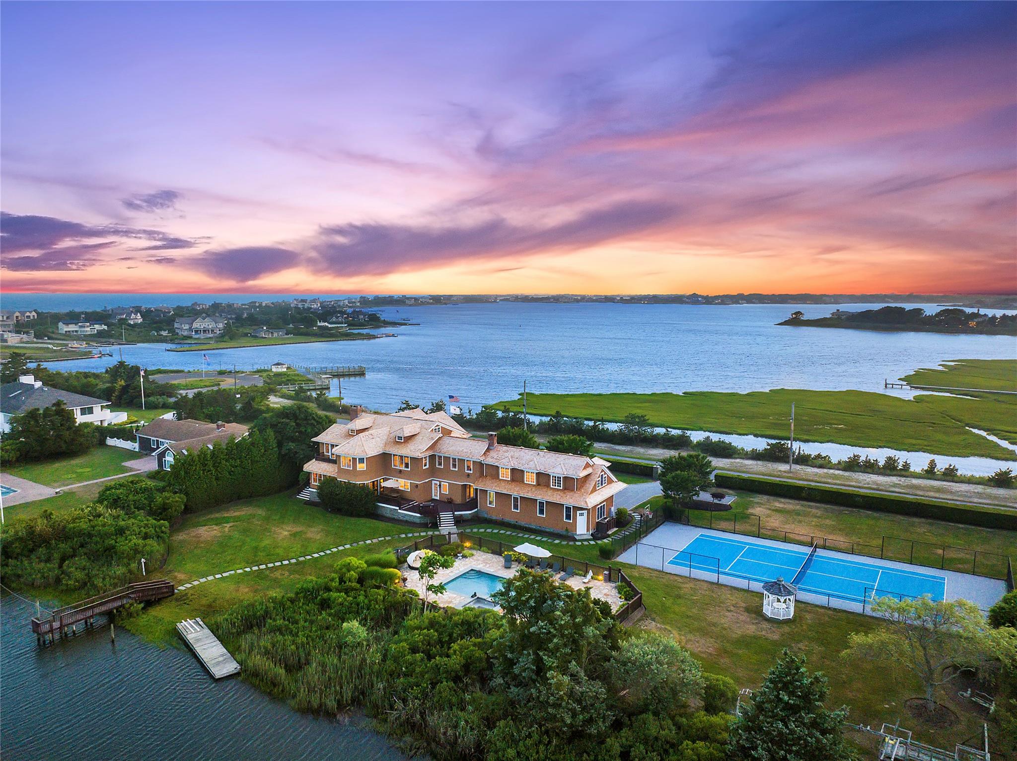 Aerial view at dusk featuring a water view