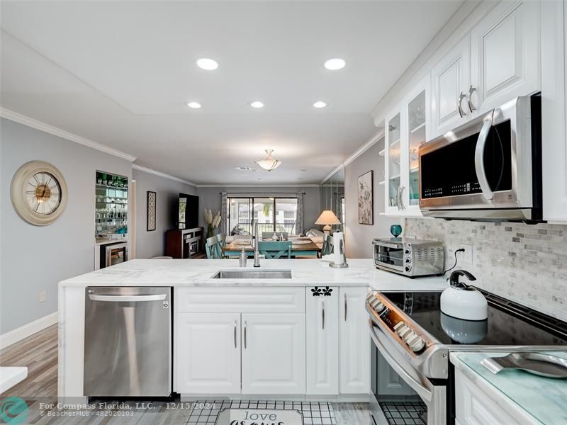 Gorgeous photo showing countertop, cabinets, kitchen appliances