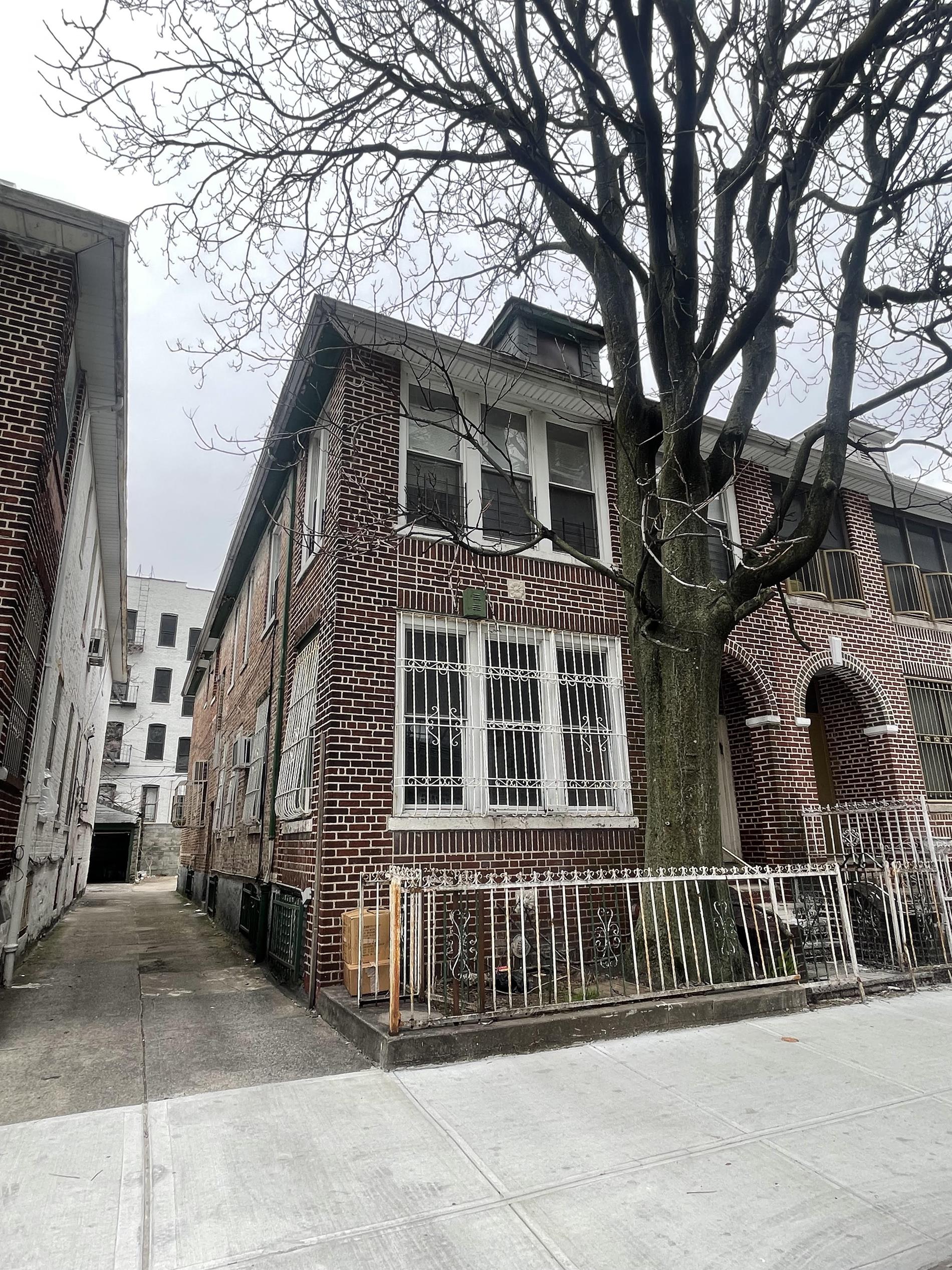 a front view of a house with a fence