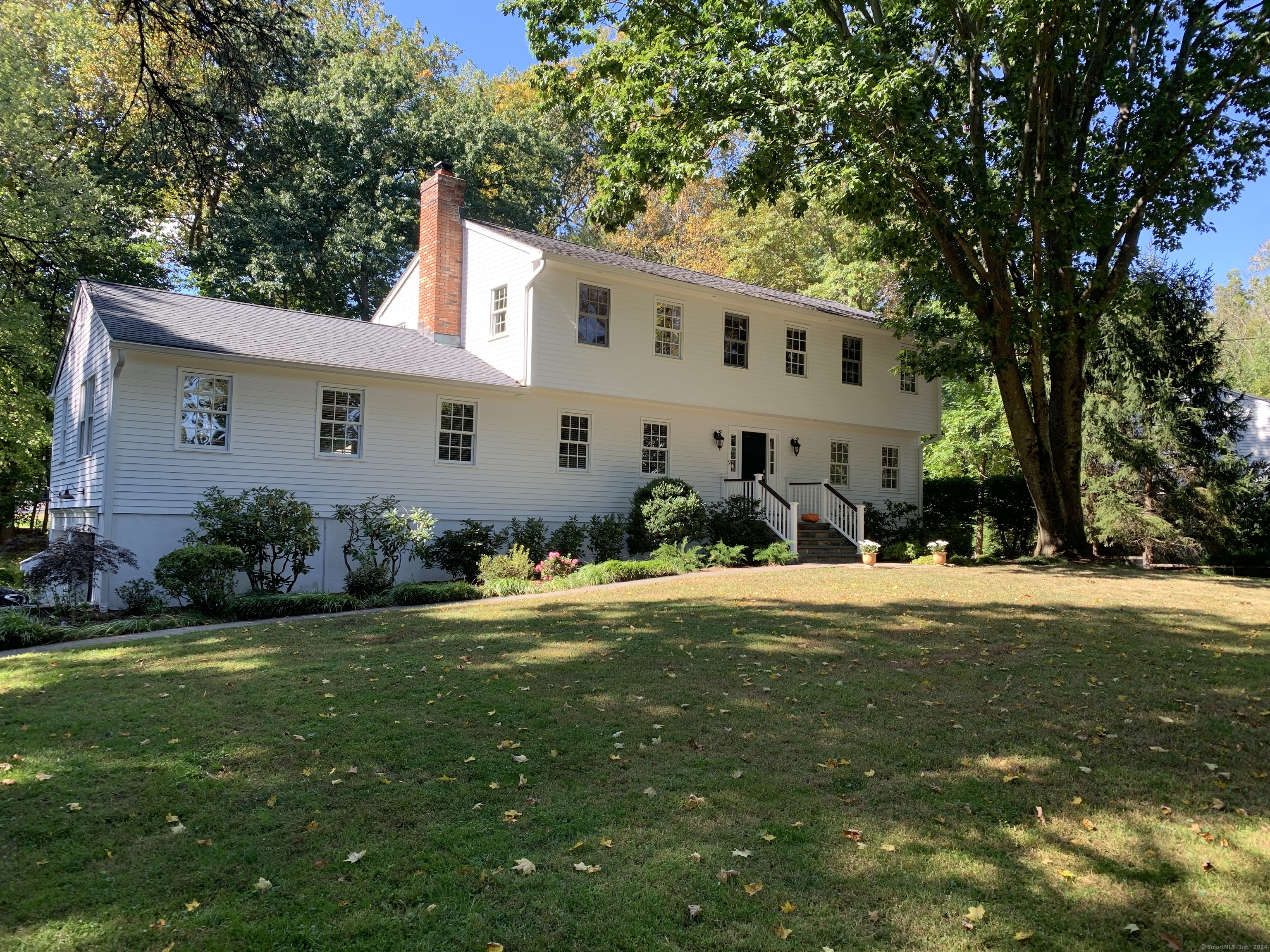 a front view of house with yard and green space