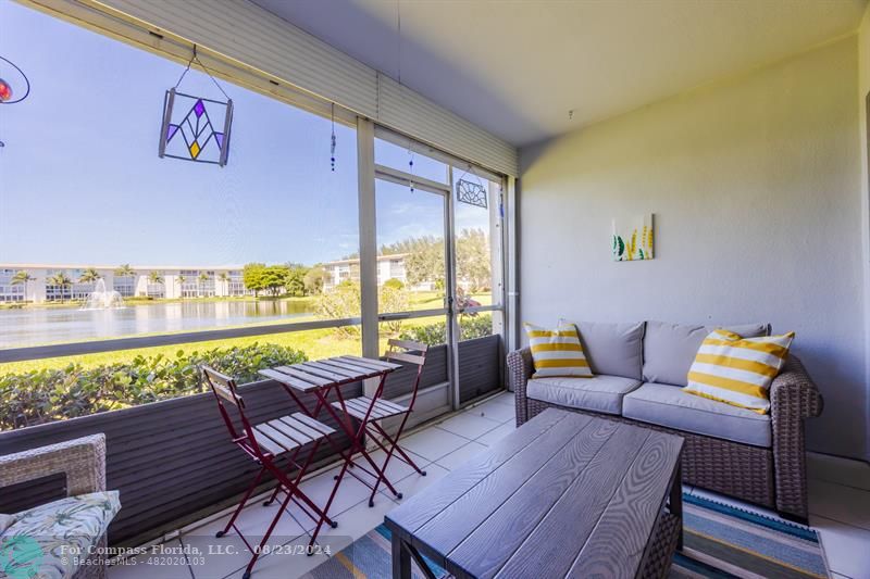 a outdoor living space with furniture and a wooden floor