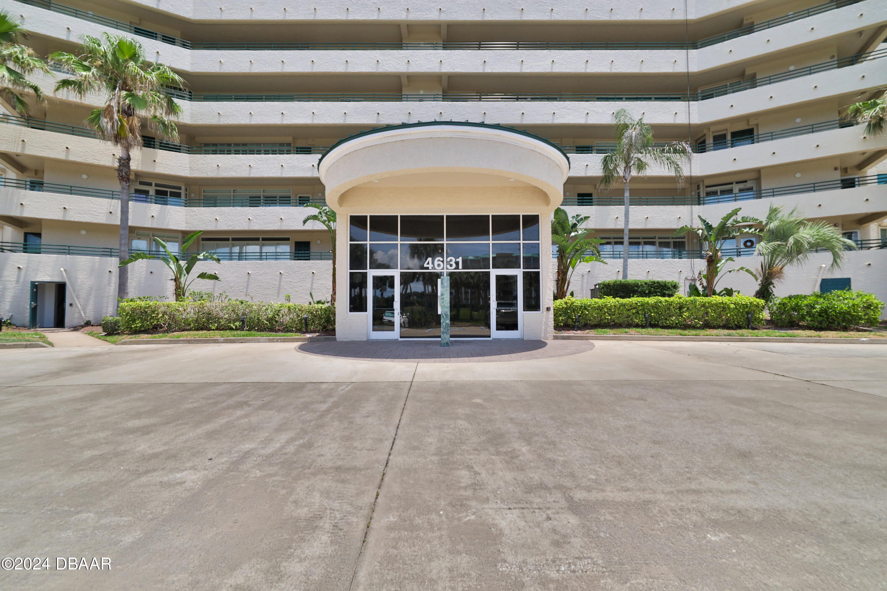 a front view of a building with a garden