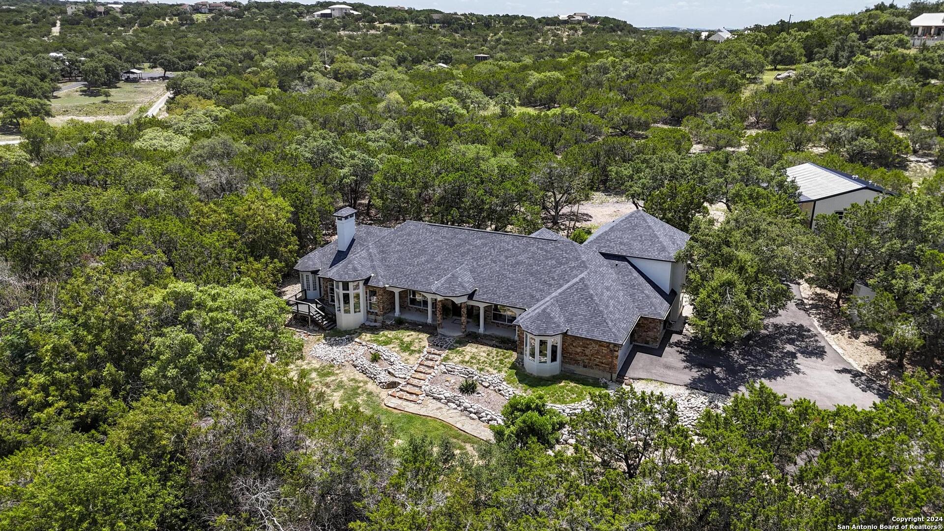 an aerial view of a house with yard and outdoor seating