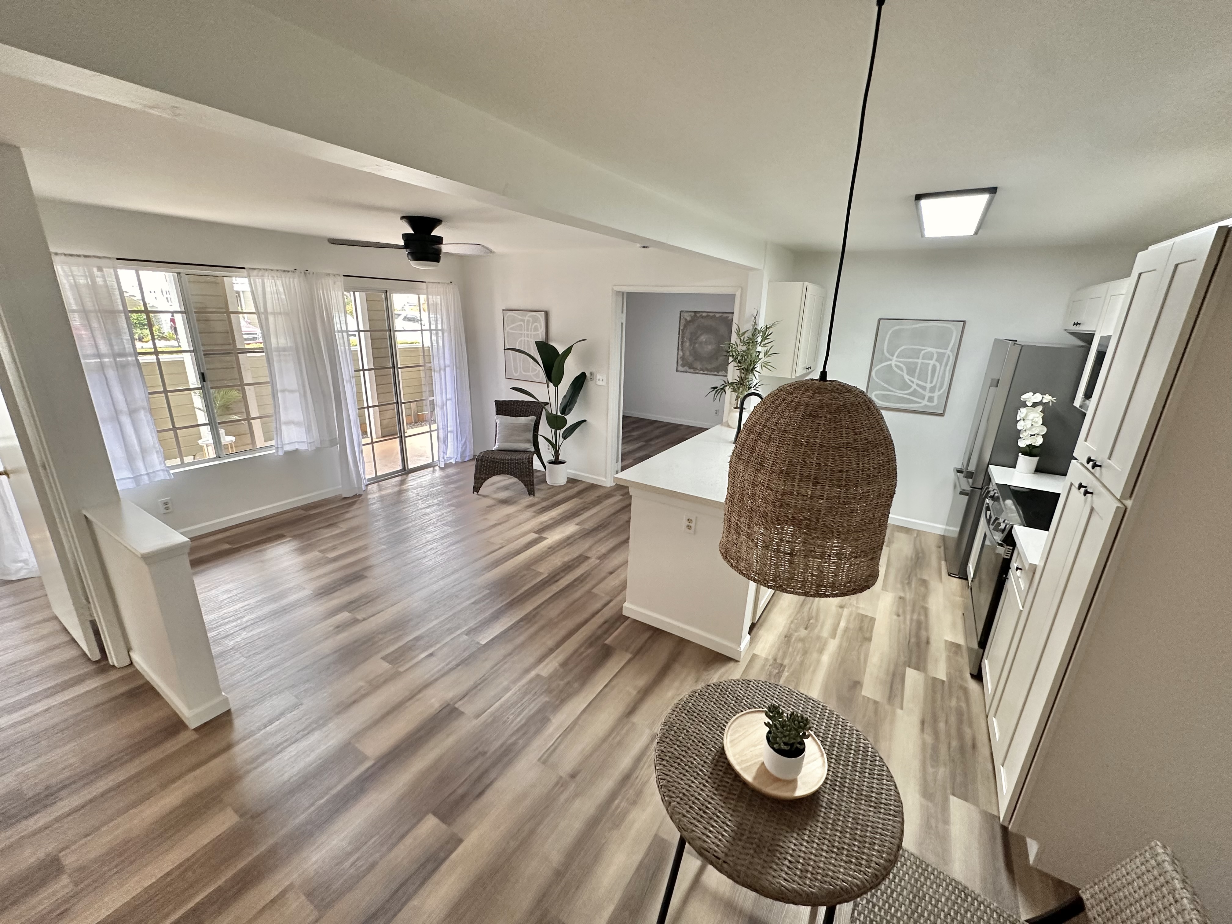 a living room with furniture and a wooden floor