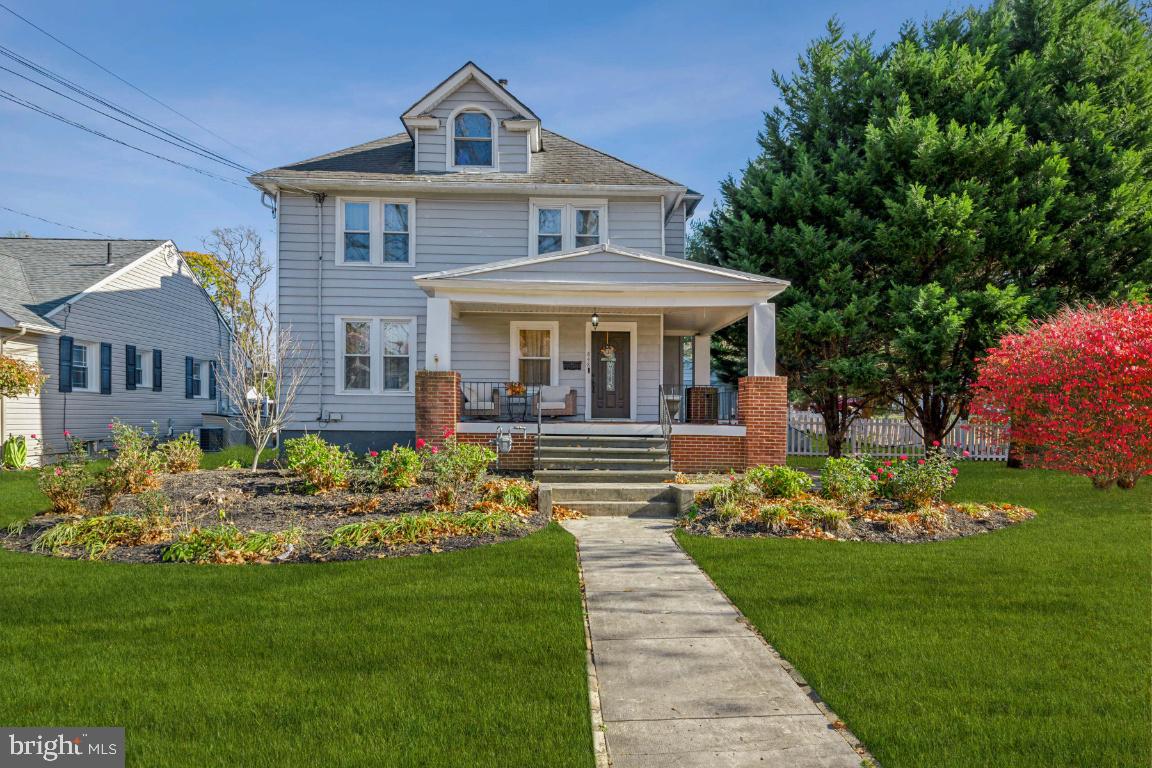 a front view of a house with a garden and porch