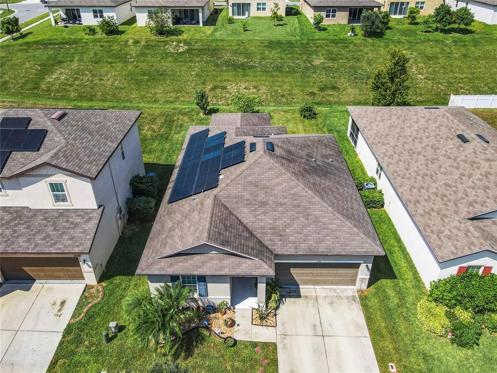 an aerial view of a house with yard patio and green space