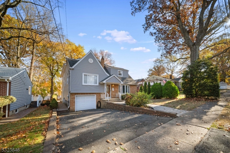 a view of a house with a big yard and large trees