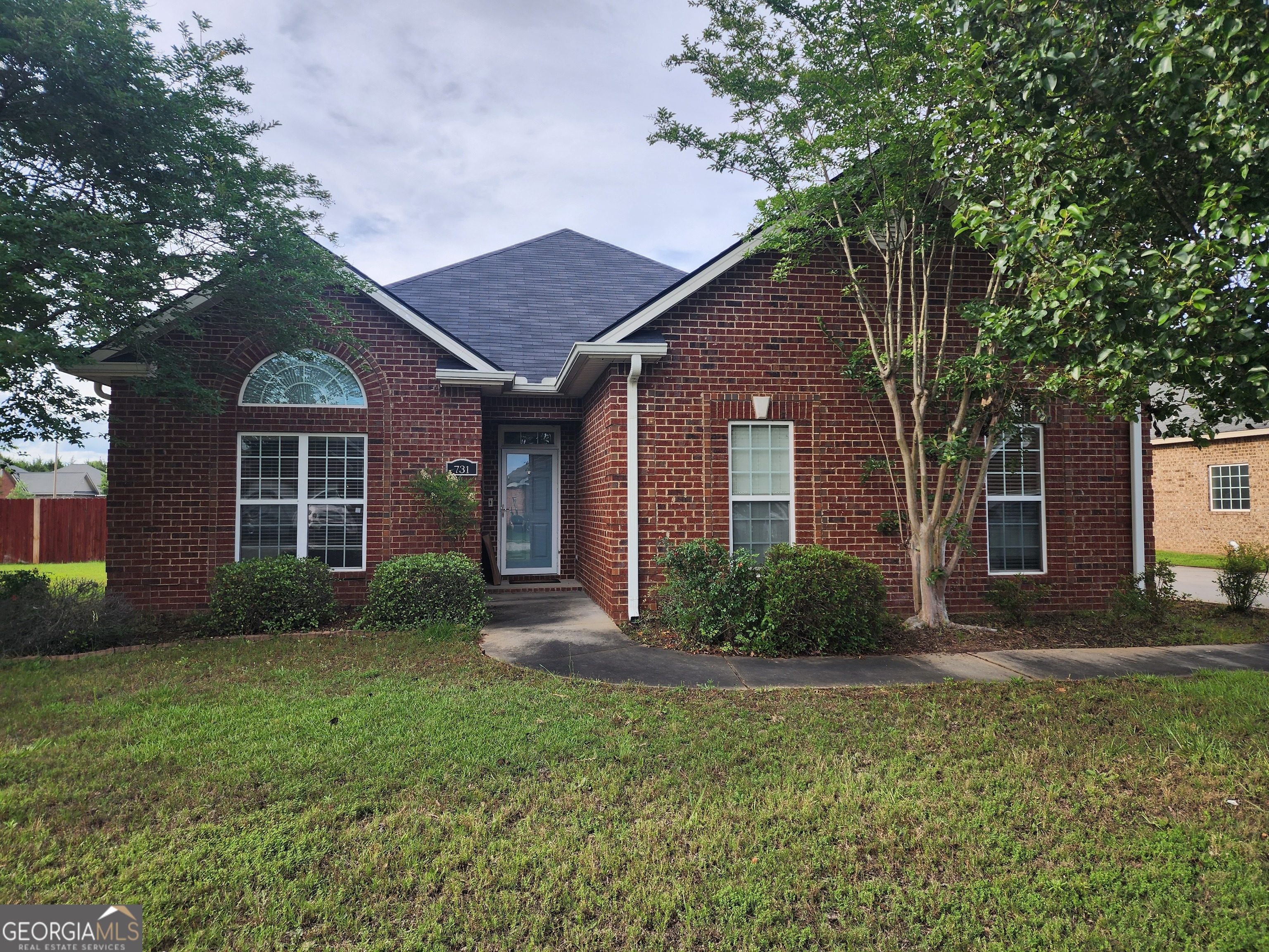 a front view of a house with garden