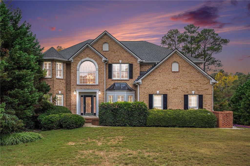 a front view of a house with a yard