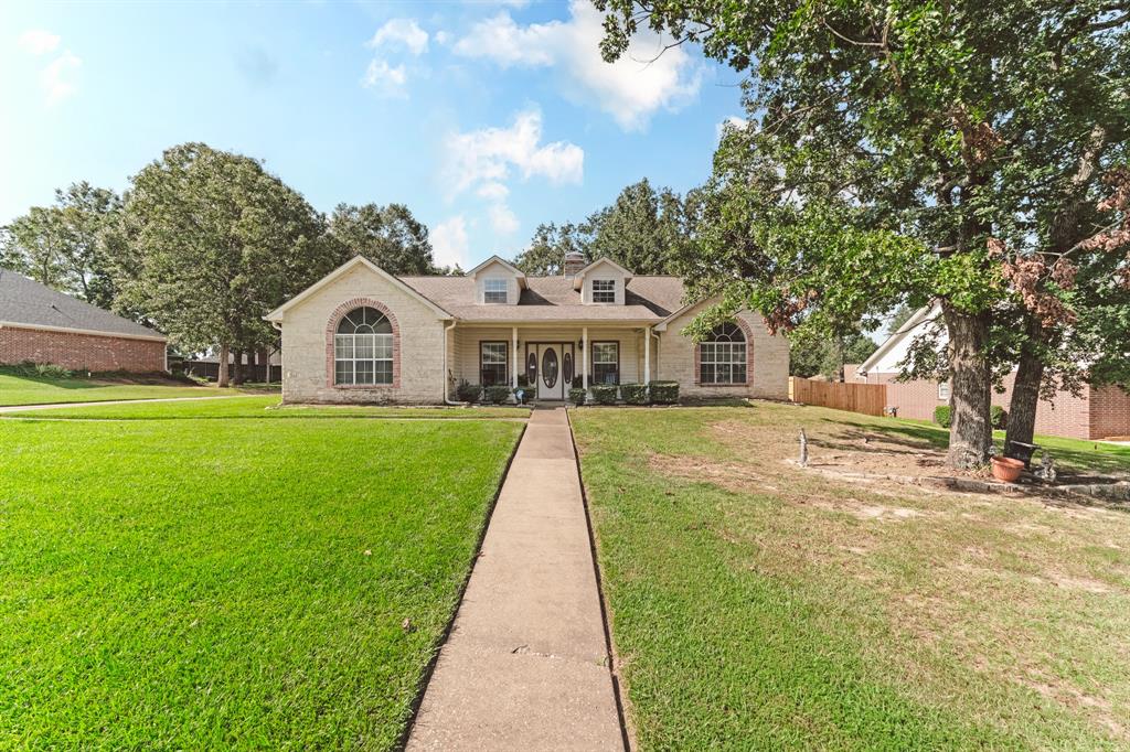 a view of house that has a yard