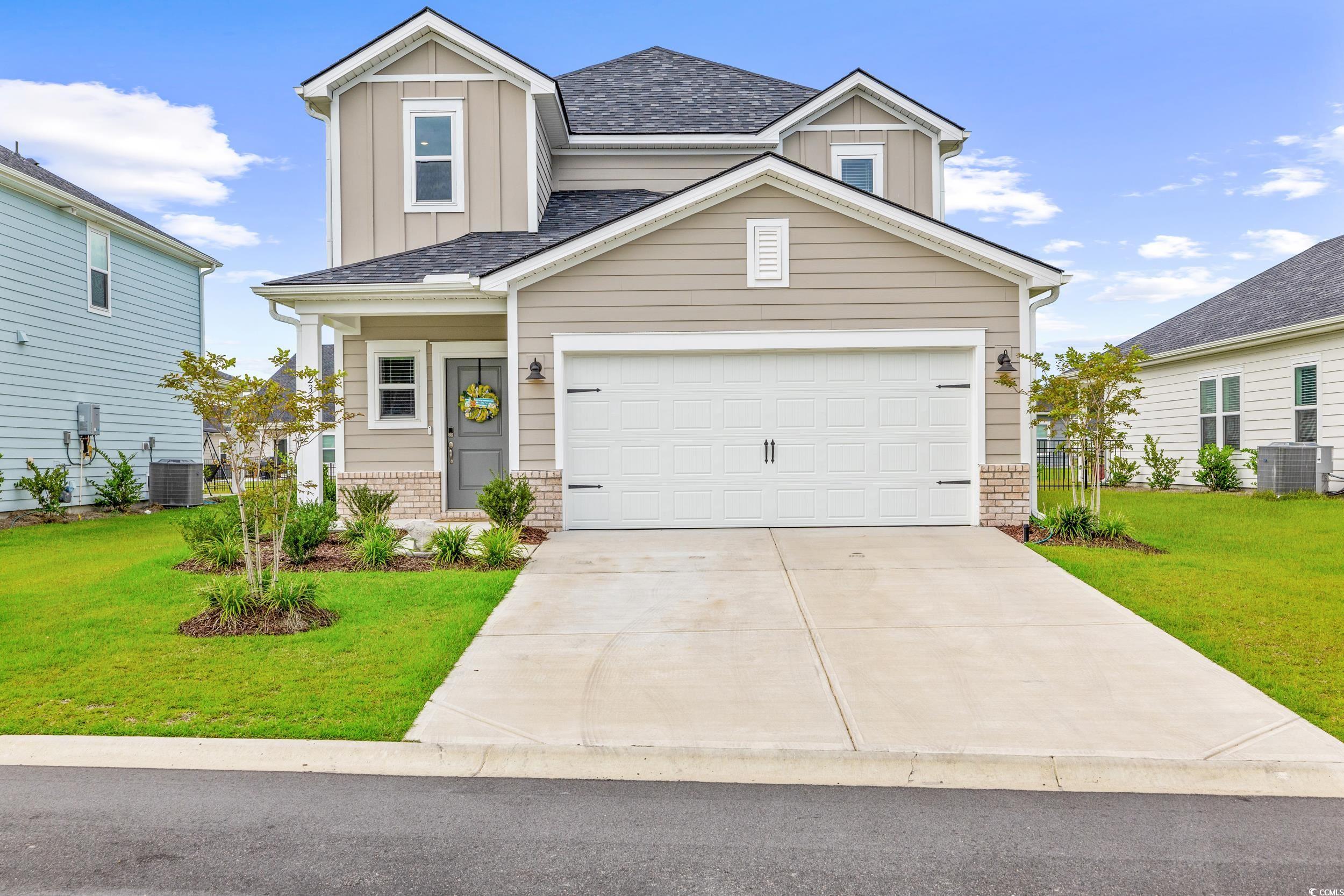 Craftsman-style house with central AC, a front yar