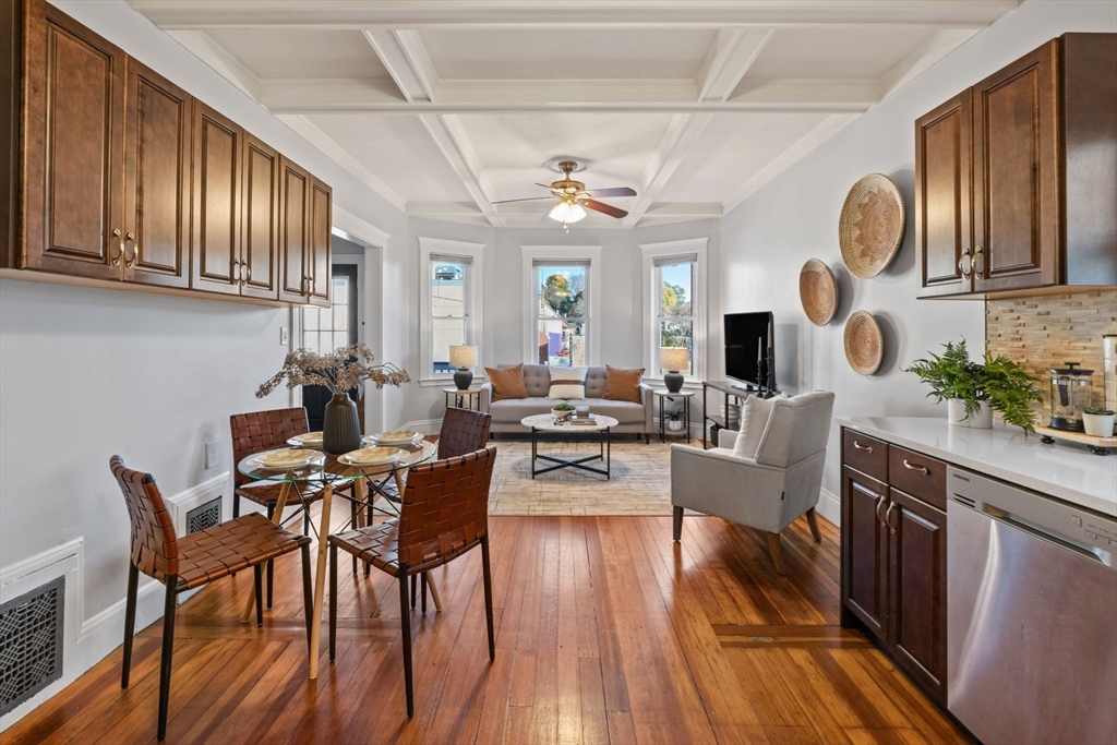 a view of a dining room with furniture chandelier and wooden floor