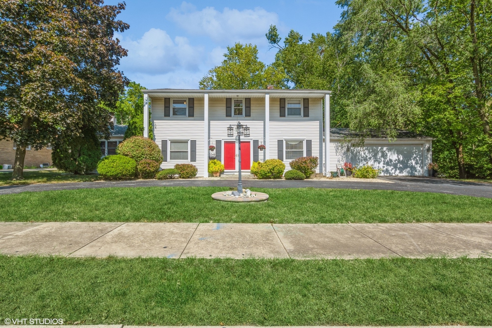 a front view of house with yard and green space