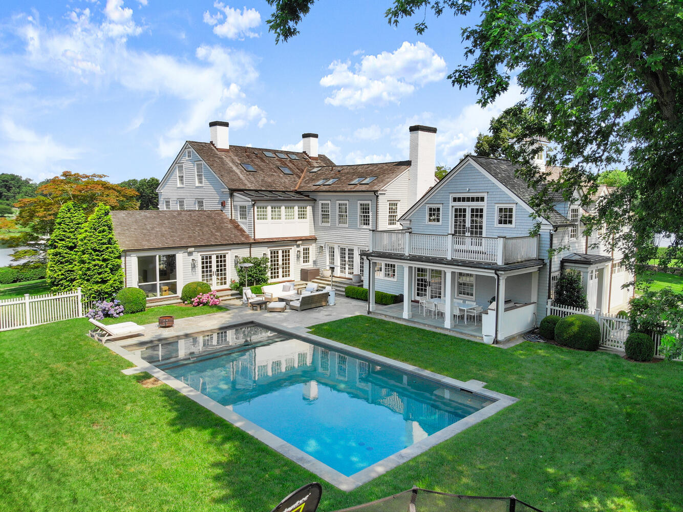 a view of a house with swimming pool and sitting area