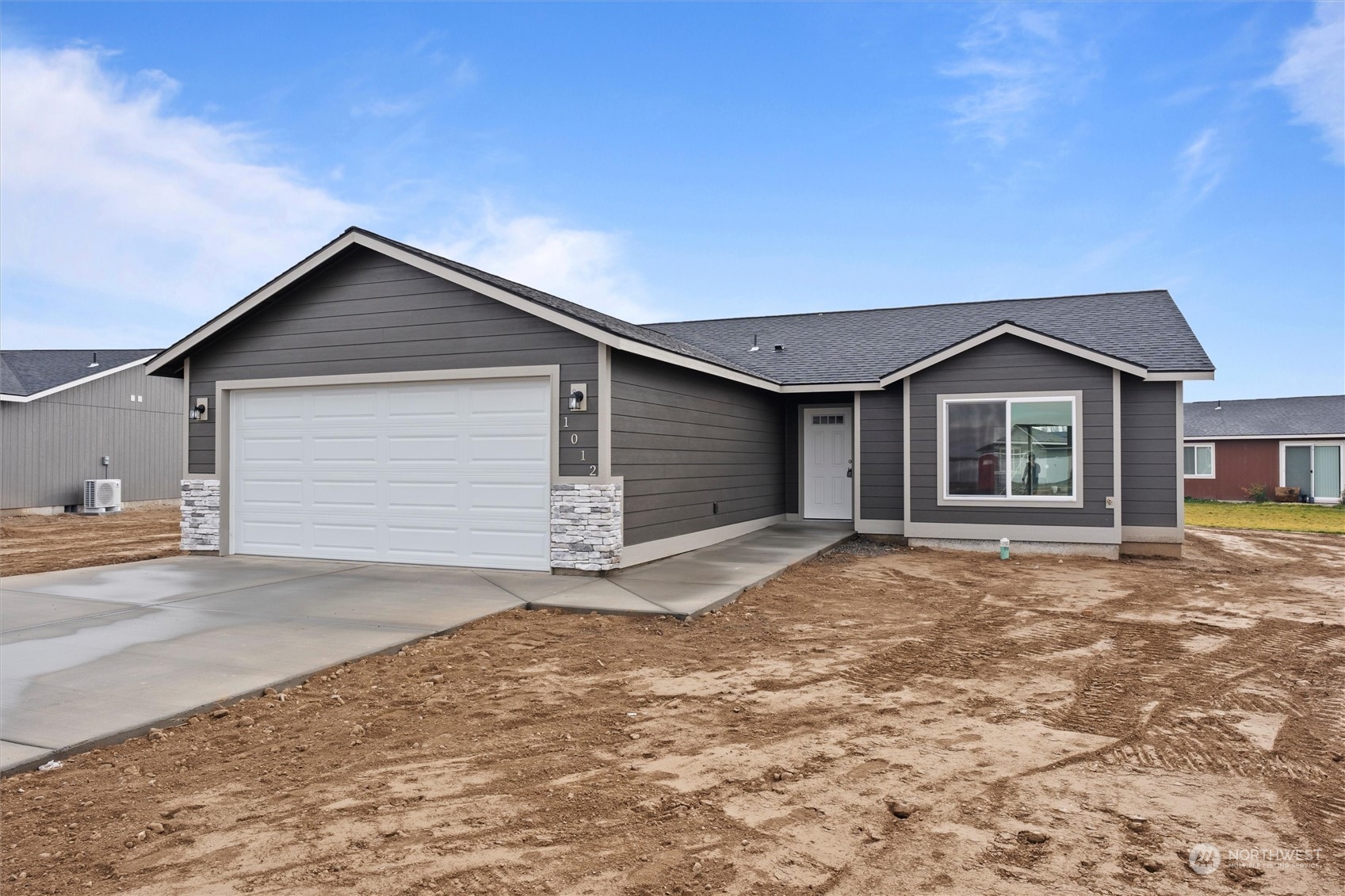 a front view of a house with a yard and garage