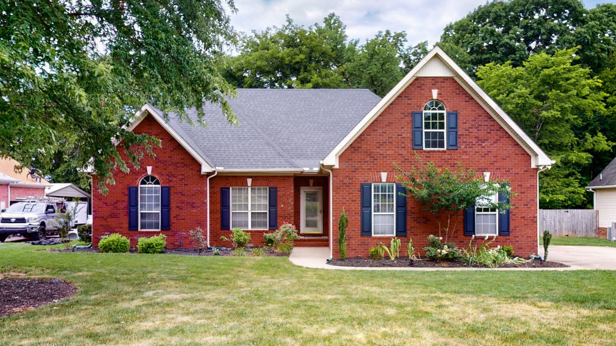 a view of a house with a yard and plants