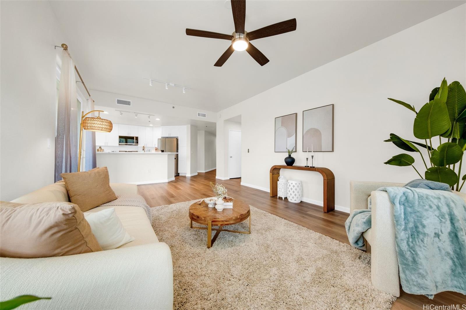 a living room with furniture and a chandelier