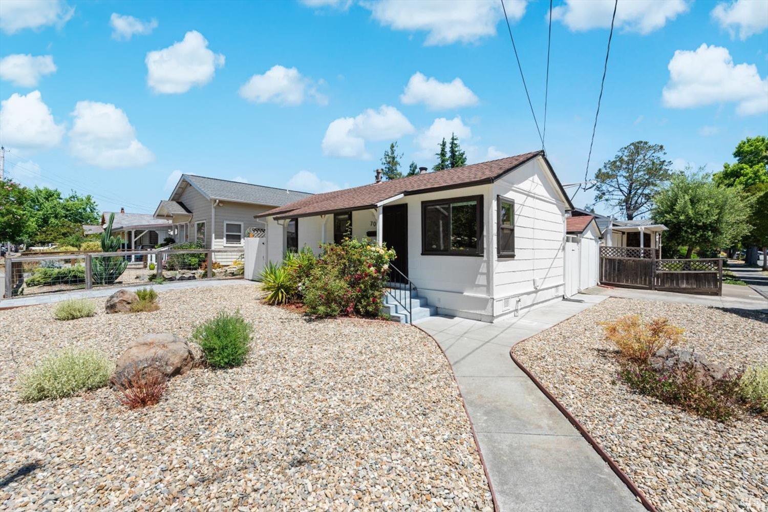 a front view of a house with garden