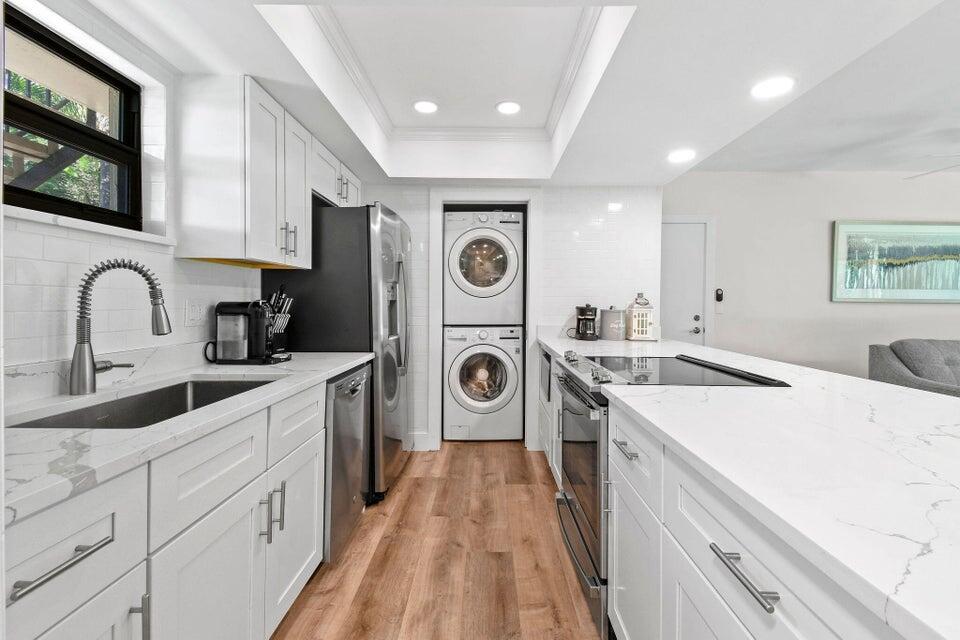 a kitchen with a sink cabinets and appliances