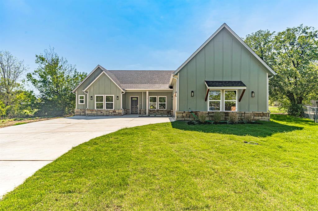 a front view of house with yard and green space