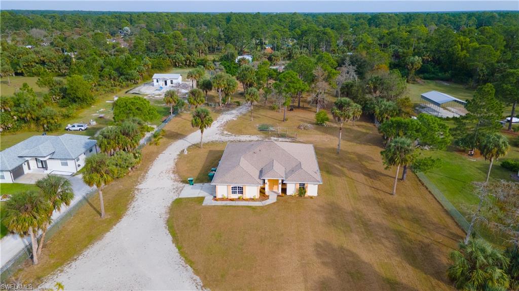 an aerial view of a house with a yard basket ball court and outdoor seating