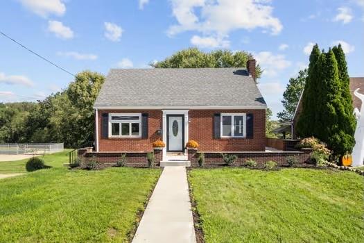 a front view of a house with a yard