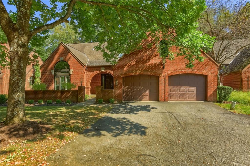 a front view of a house with a yard garage and outdoor seating