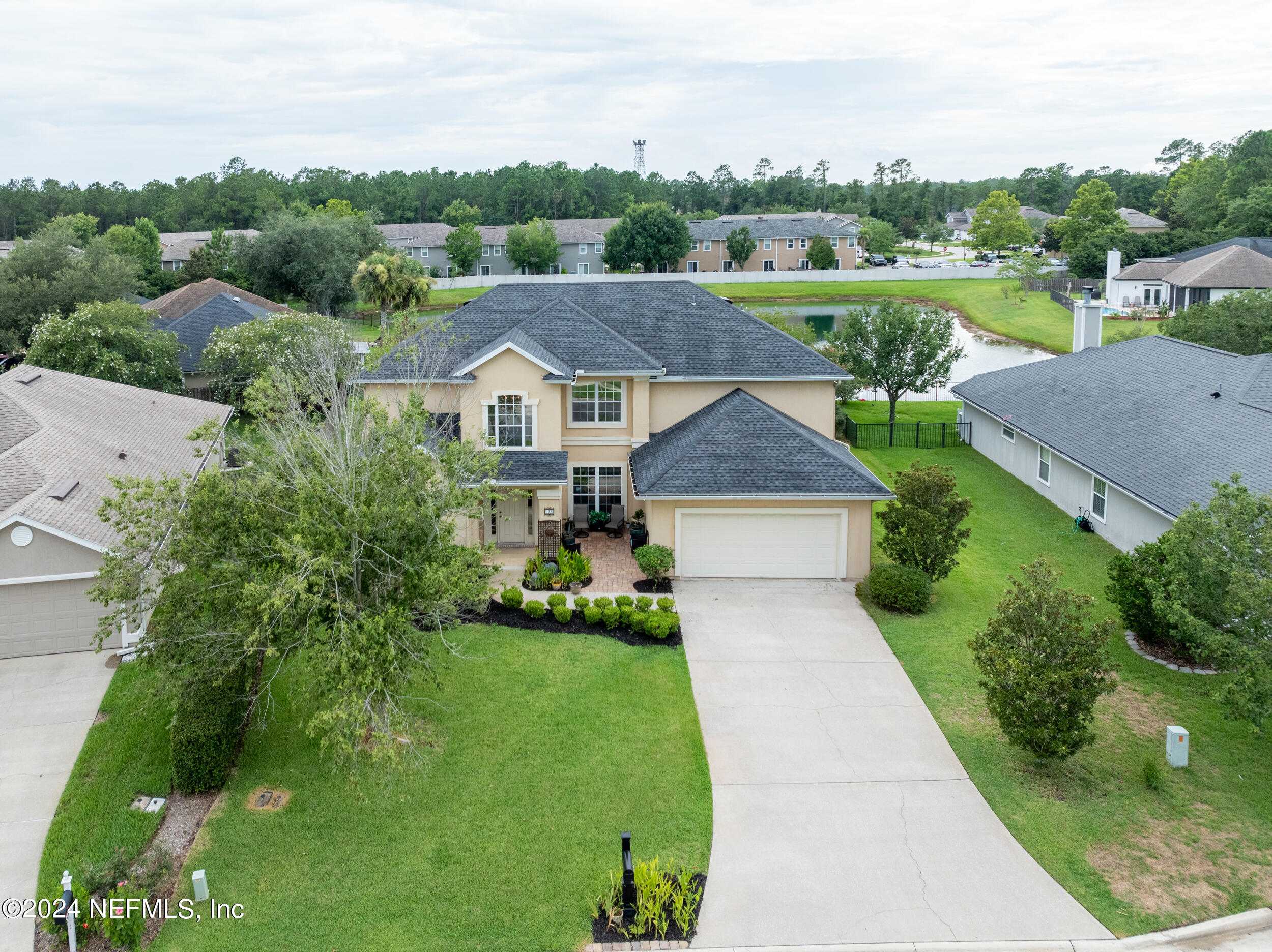 an aerial view of a house with big yard