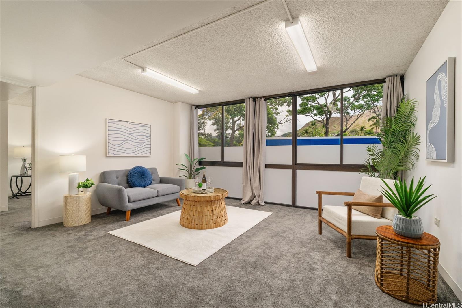 a living room with furniture large window and potted plants