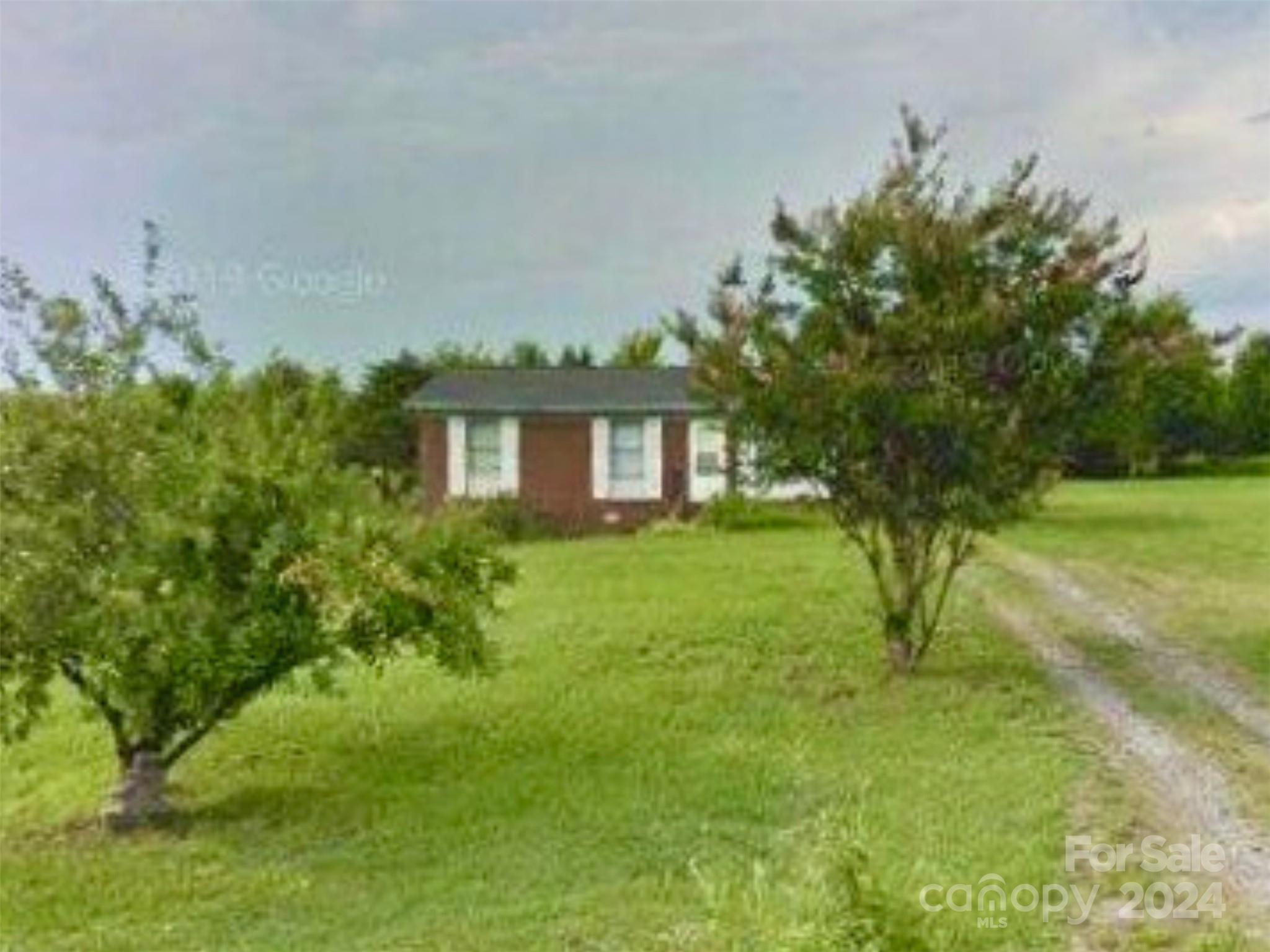 a view of house with backyard