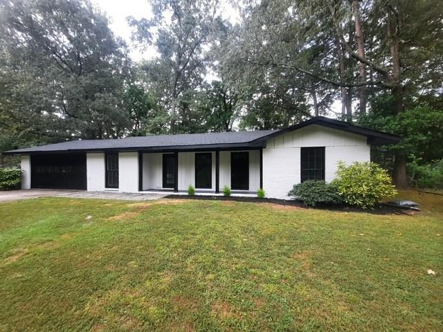 a front view of house with yard and green space