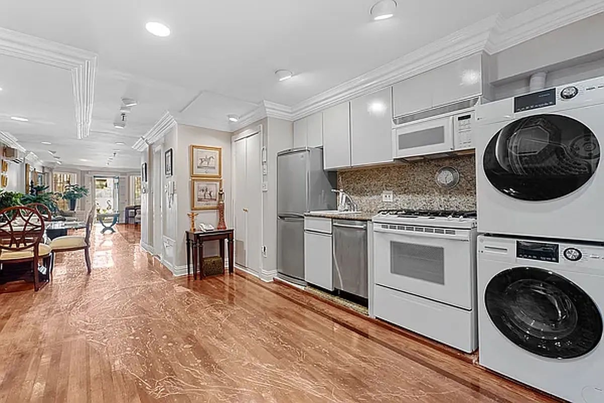 a kitchen with granite countertop a sink a stove and cabinets