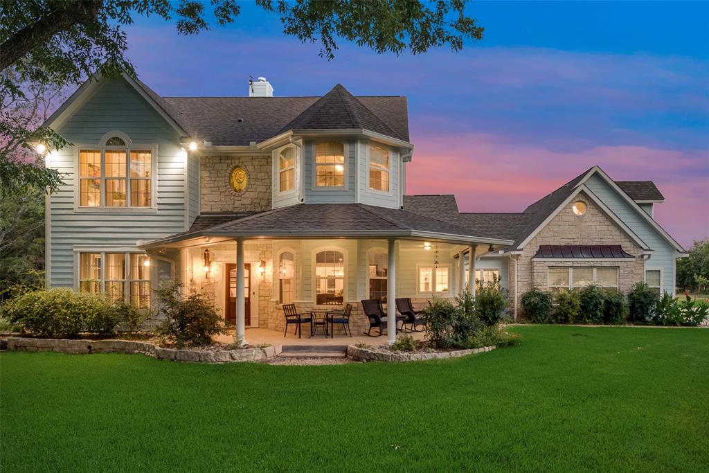 a view of a house with backyard porch and sitting area