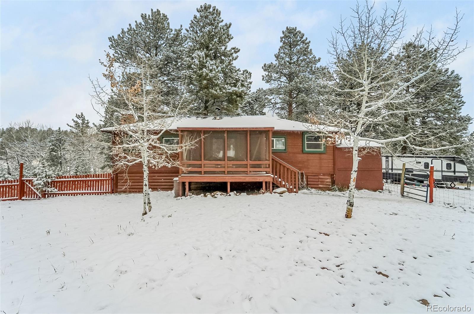 a backyard of a house with barbeque oven and tree