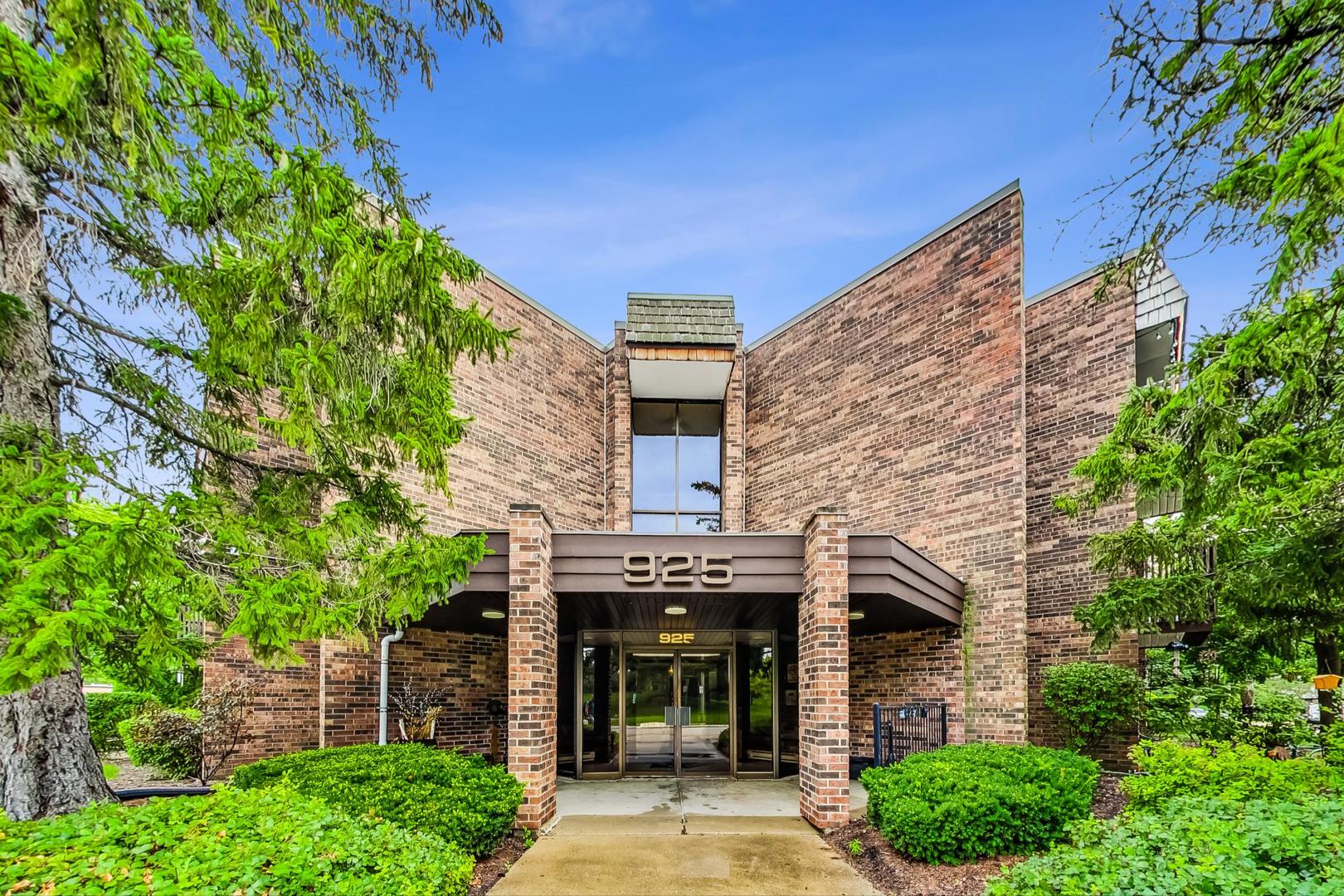 front view of a brick house with a small yard