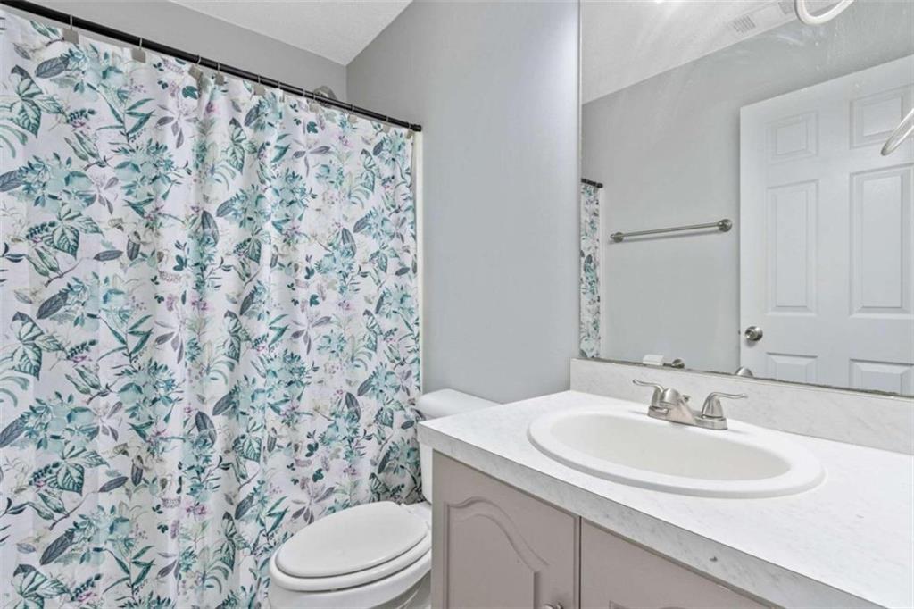 a bathroom with a sink toilet and mirror