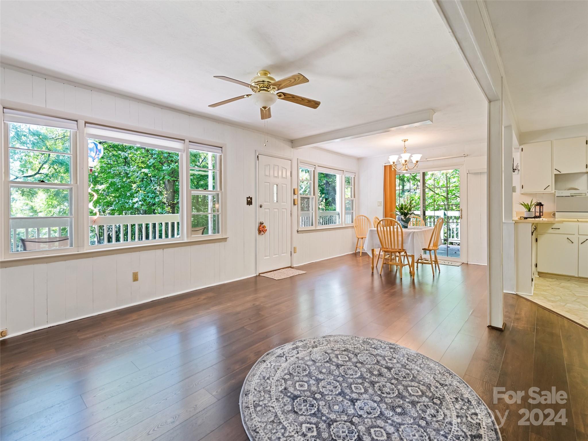 a living room with furniture and a floor to ceiling window