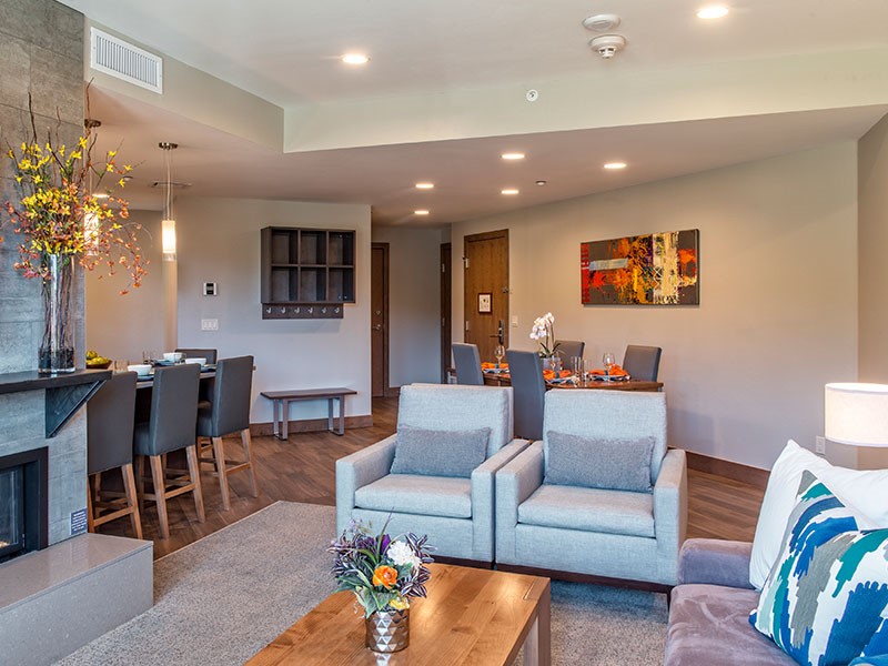 a living room with furniture kitchen and a chandelier