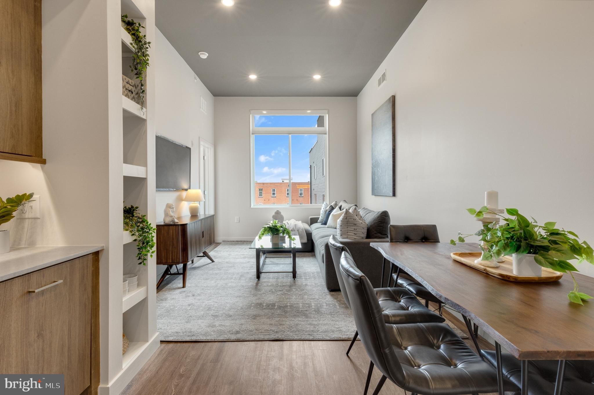 a living room with furniture potted plant and a window