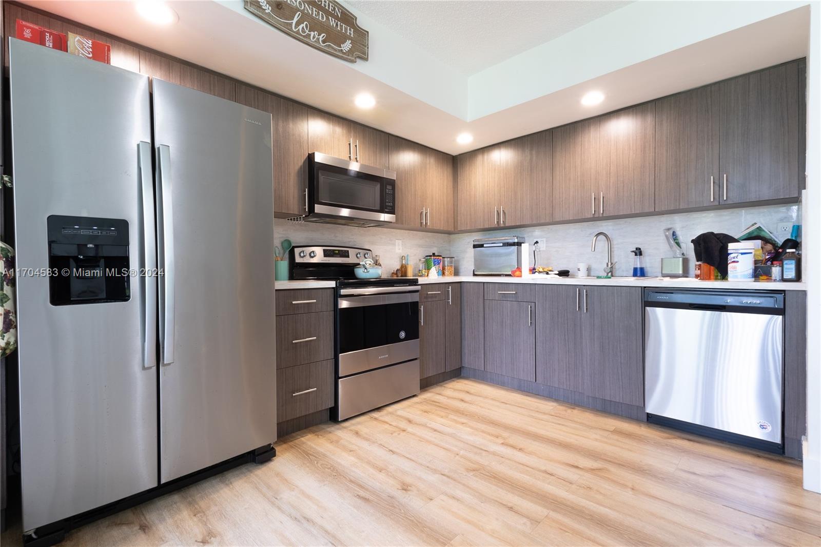 a kitchen with stainless steel appliances a refrigerator and a stove top oven