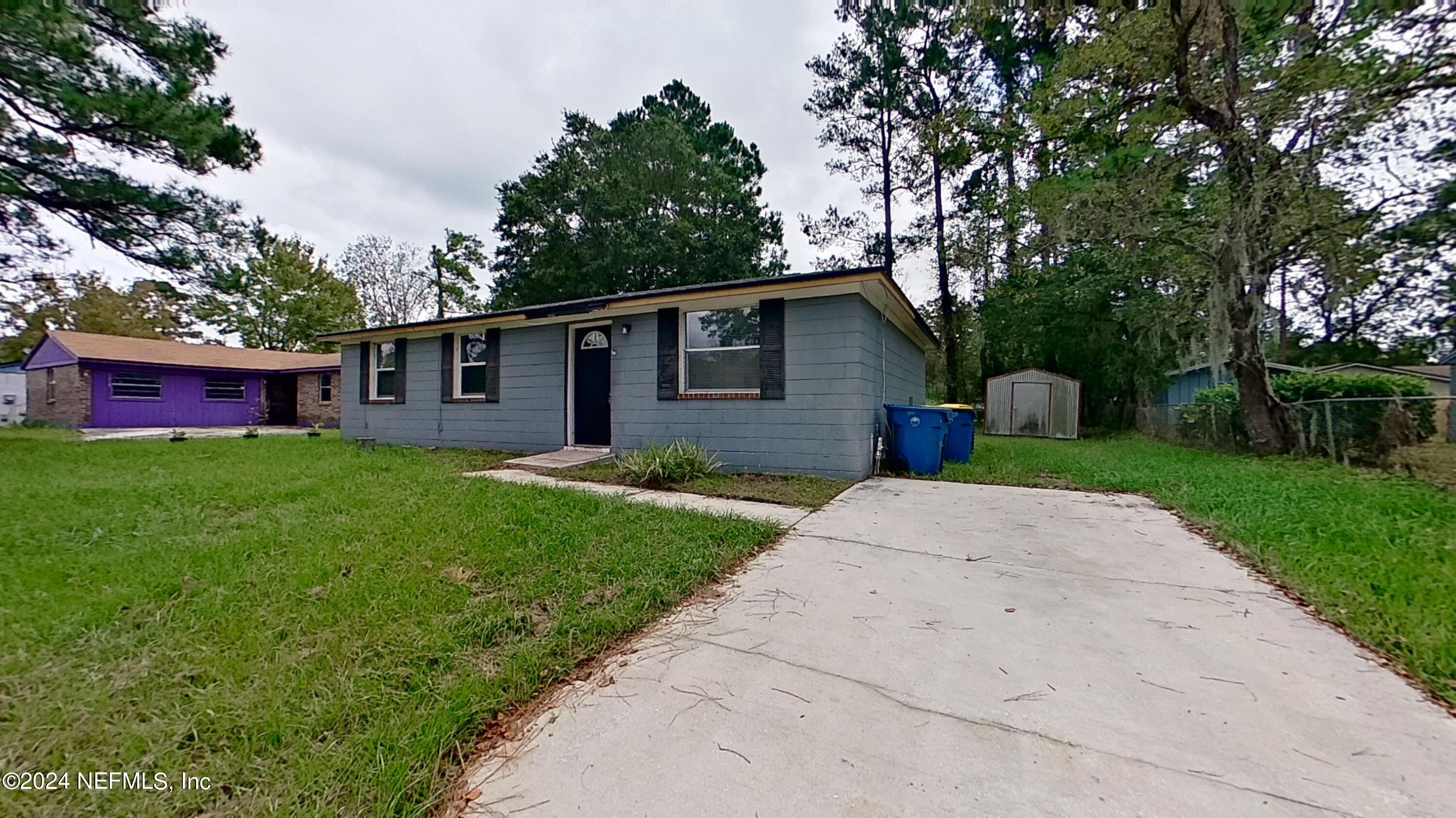 a view of house with a yard