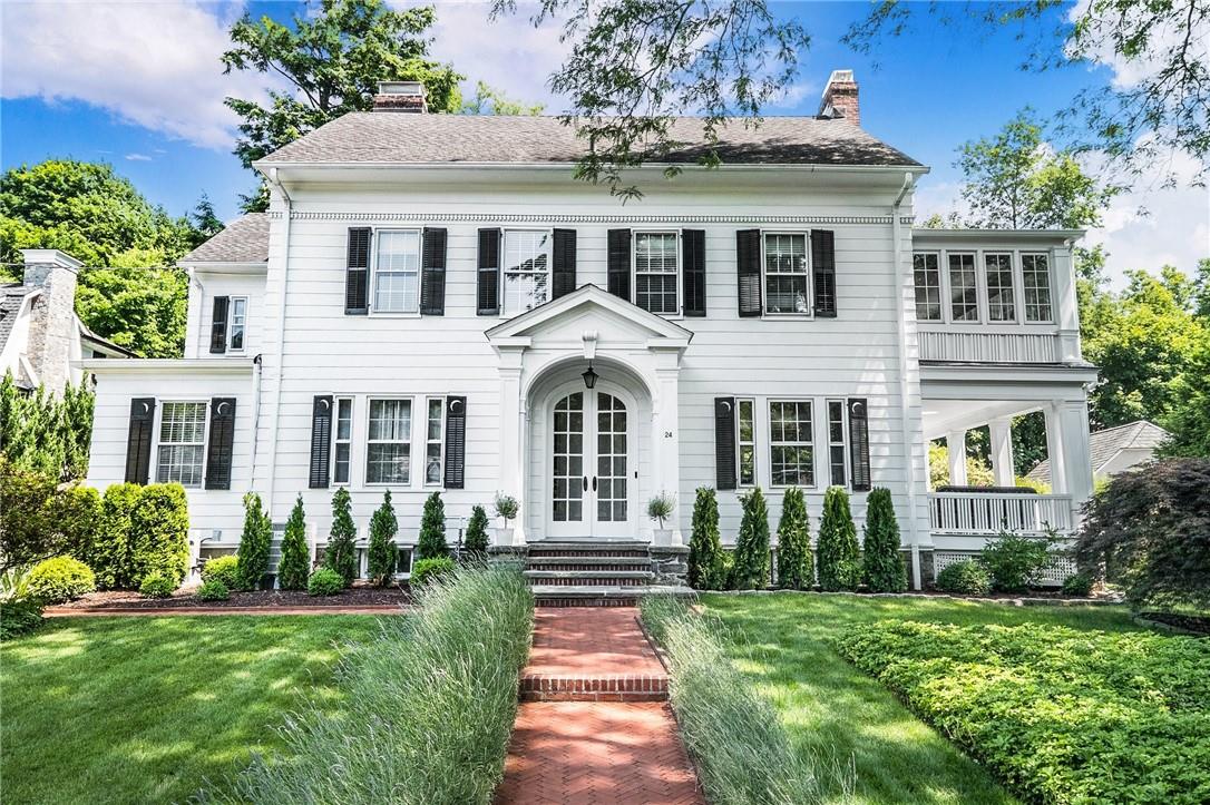 a front view of a house with a garden