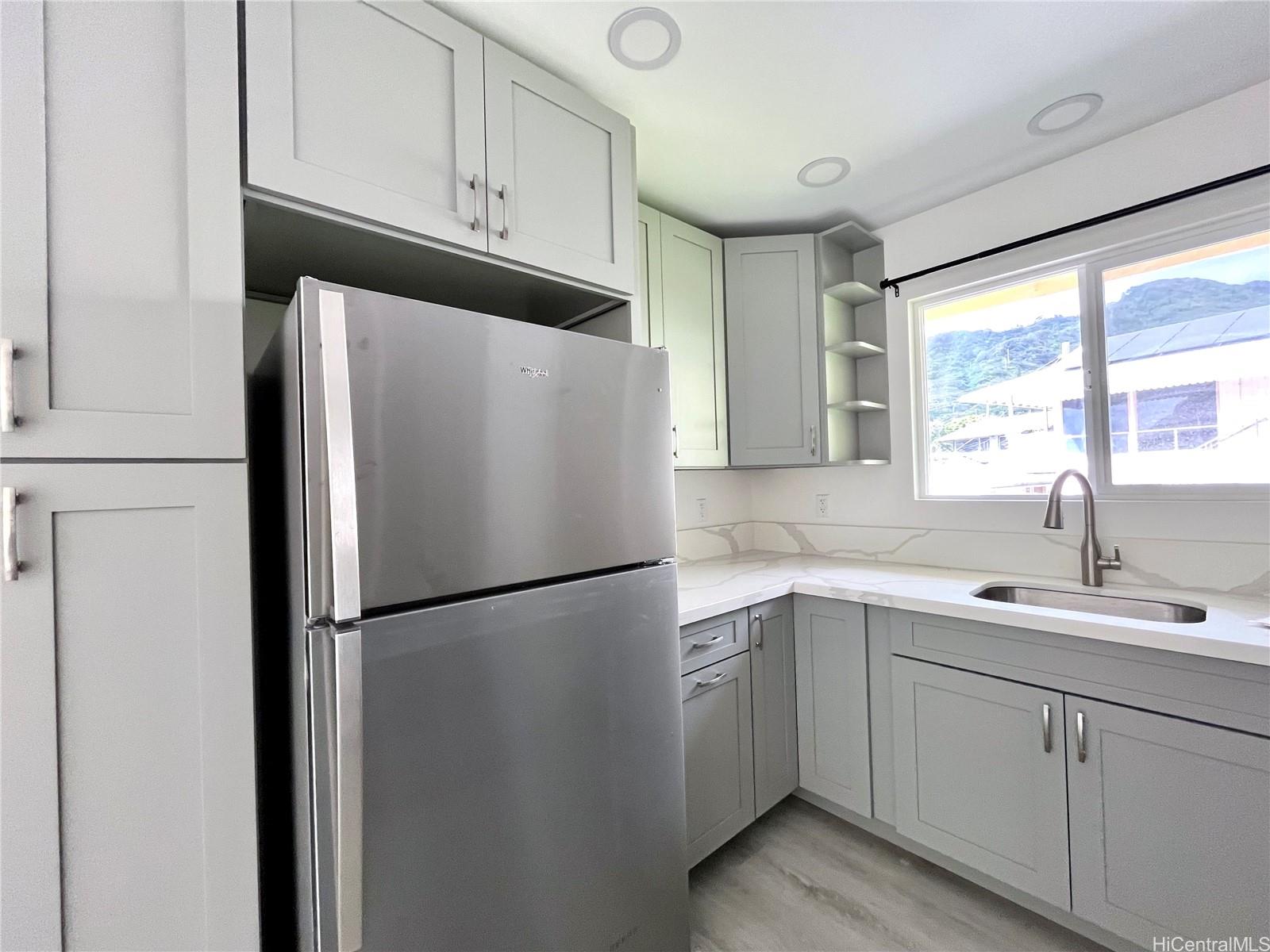 a white refrigerator freezer sitting in a kitchen