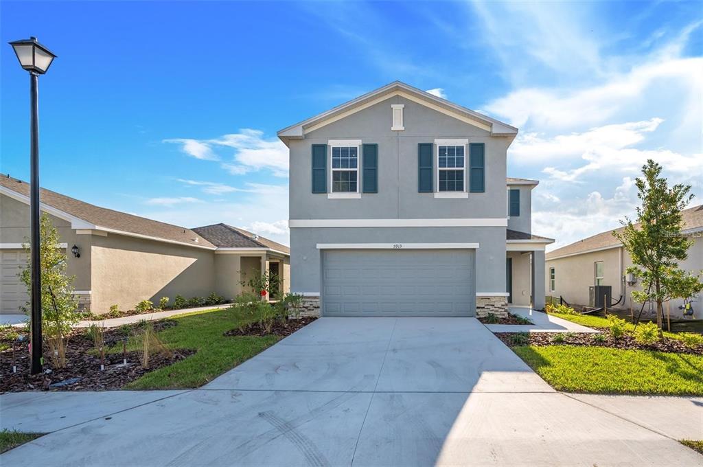 a front view of a house with a yard and garage