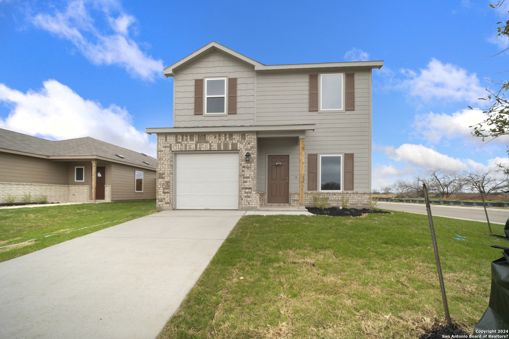 a front view of a house with a yard