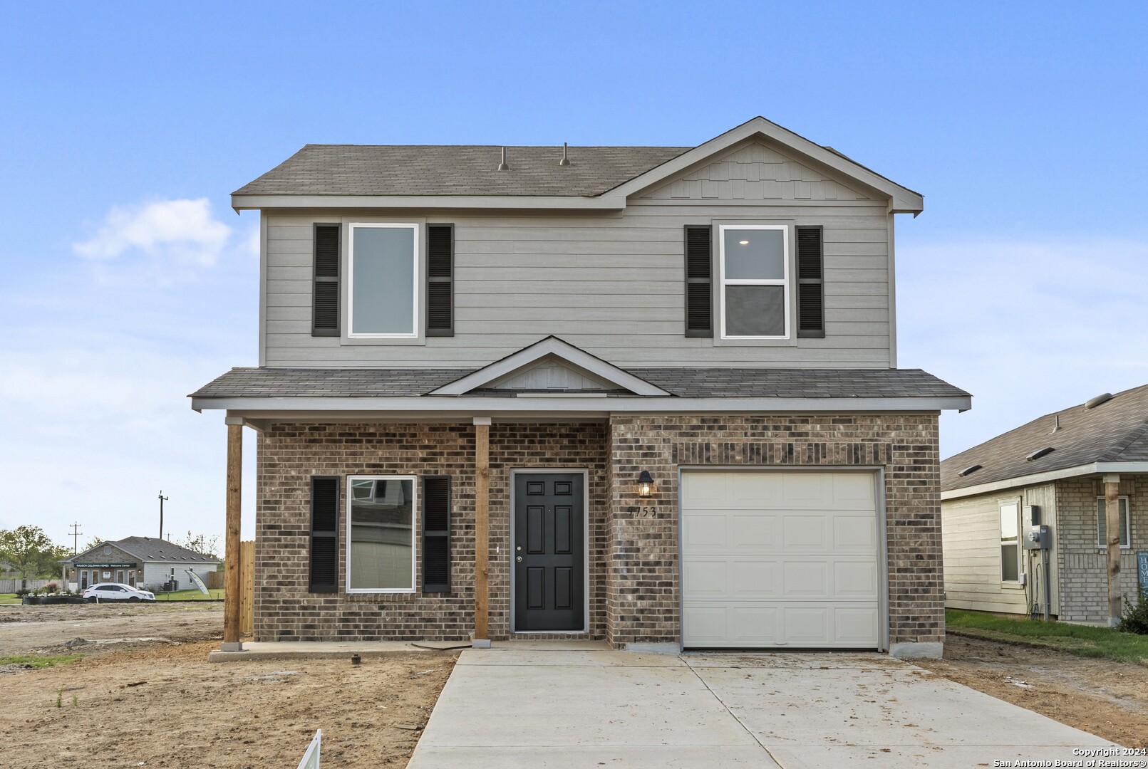 a front view of a house with a yard