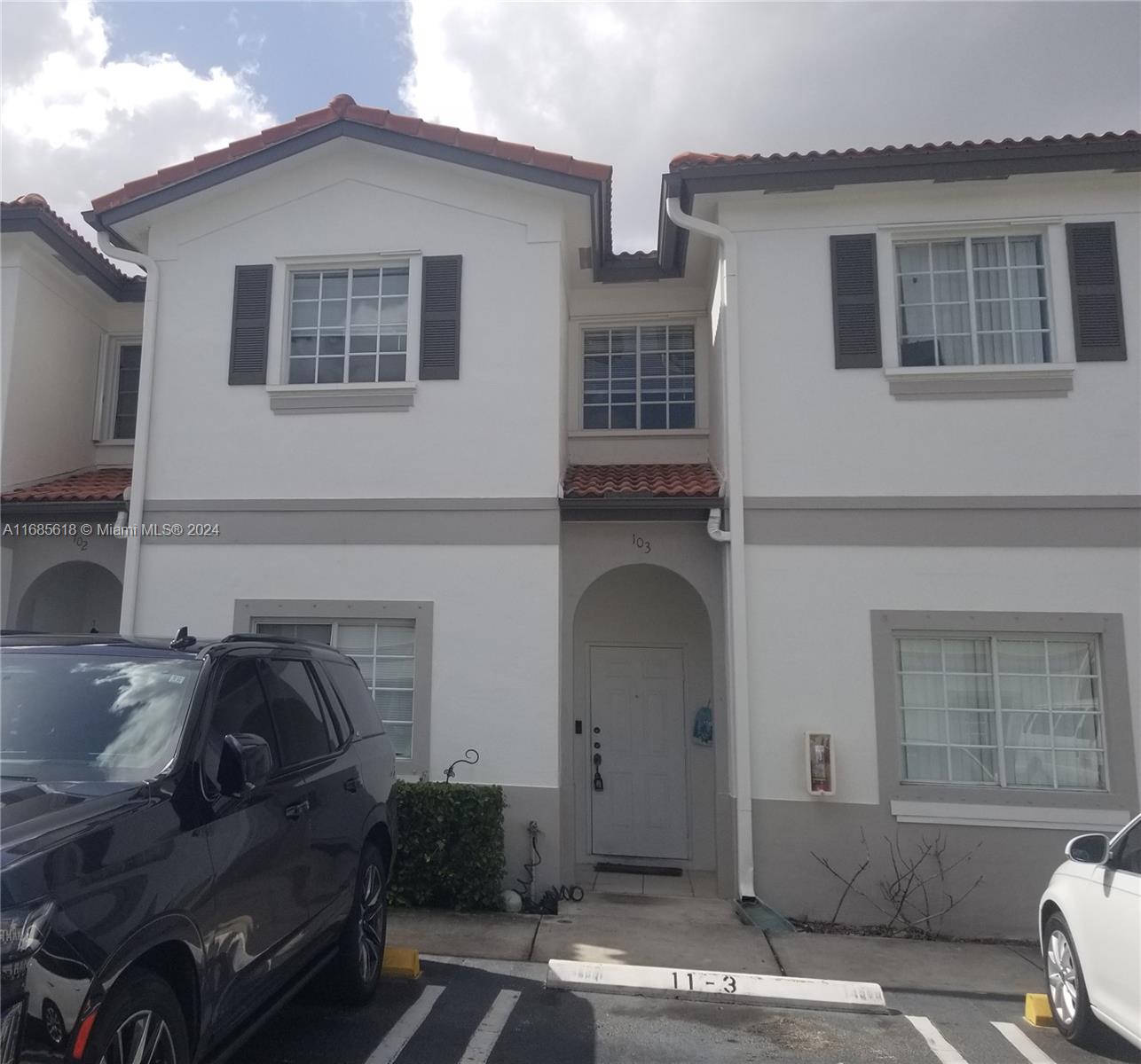 a front view of a house with parking space